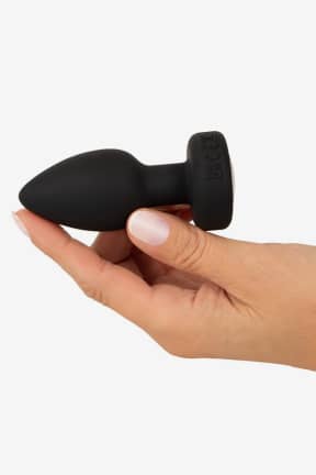 Buttplug Anos - RC Flashing Butt Plug with Vibration - Kompakt, blød buttplug i silikone med 7 vibrationsmønstre og fjernbetjening. Vandtæt og USB-opladelig - med fræk LED, der blinker med på legen.